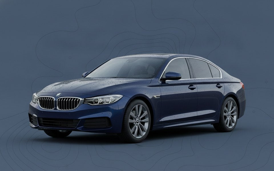 Freshly rinsed dark blue sedan with clean water sheeting off spot-free paintwork